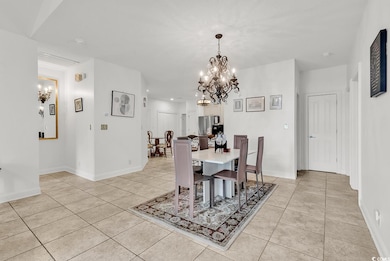 Dining room with a chandelier and tile floors