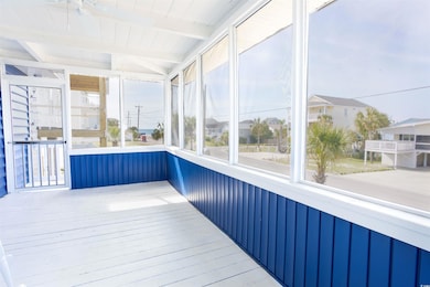 Unfurnished sunroom with beam ceiling and a residential view
