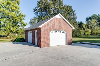 The fabulous detached garage provides additional storage for a vehicle & lawn equipment.