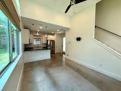 Unfurnished living room with baseboards, concrete