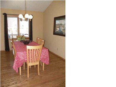 Family dining area with hardwood flooring