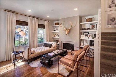 Living room with custom fireplace, drapery and bui
