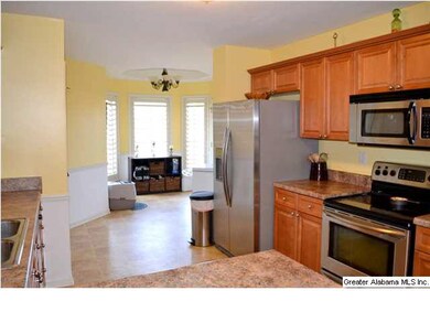 Large eating area with tray ceiling and bay window