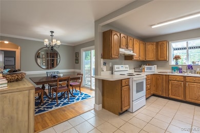 Kitchen with white appliances, under cabinet range