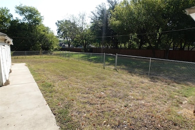 View of yard with two gates in fence.