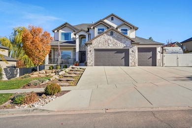Traditional home with driveway, a gate, covered porch, stone siding, and an attached garage
