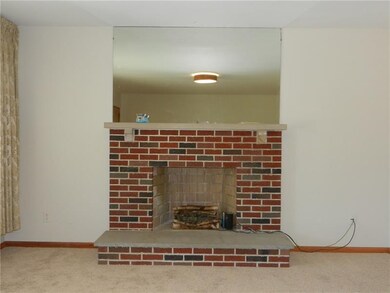 Wood burning fireplace in living room.