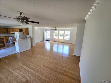 living room featuring ornamental molding, ceiling fan, and bamboo flooring