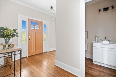 Entrance foyer featuring baseboards, light wood-st