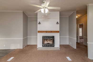 To the right of the fireplace is the hallway leading to 3 bedrooms and a full bathroom.