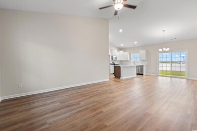Unfurnished living room with light wood-type flooring, a ceiling fan, a chandelier, high vaulted ceiling, and recessed lighting