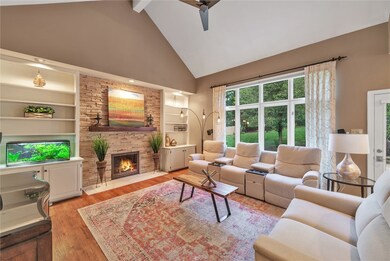 Family Room with vaulted ceiling, gas-lit fireplac