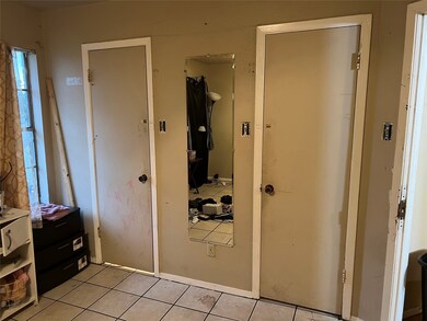 Bedroom featuring tile patterned floors and a closet