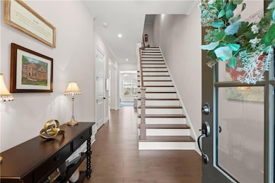 Bright, open entry with hardwood floors and natura