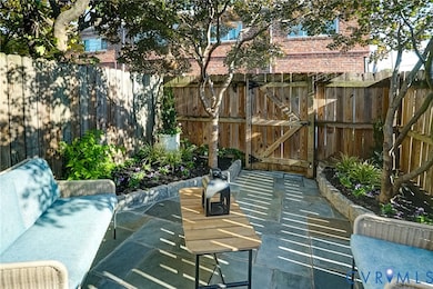 View of patio featuring a gate