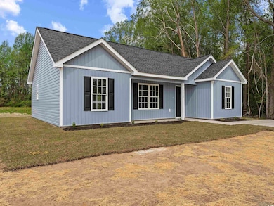Ranch-style house featuring a front lawn and roof with shingles