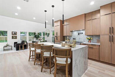 Kitchen featuring light wood-style flooring, a cen