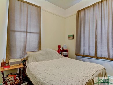 Large bedroom with tall windows--lots of natural l