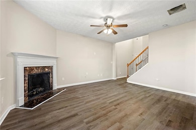 Unfurnished living room with stairs, wood finished