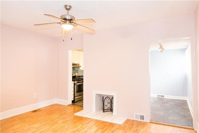 Living room with newer flooring and decorative fir