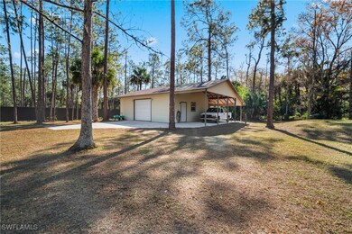 View of side of property with a lawn and a garage