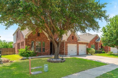 View of front of property featuring a front lawn and a garage