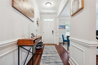 Foyer with dark hardwood / wood-style floors and o