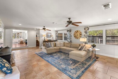Living room featuring visible vents, baseboards, 