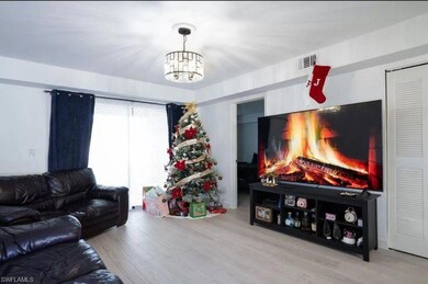 Living room with an inviting chandelier and wood-t