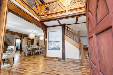 Entry with custom pine door and reclaimed wood beams