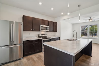 Kitchen with stainless steel appliances, a sink, l