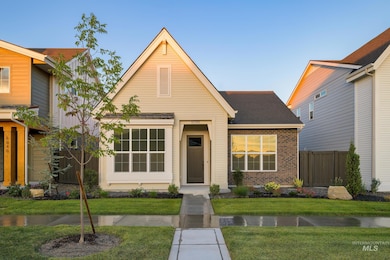 View of front of property featuring brick siding and a shingled roof