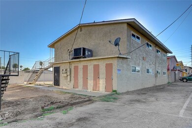 Rear view of house with stucco siding, cooling uni