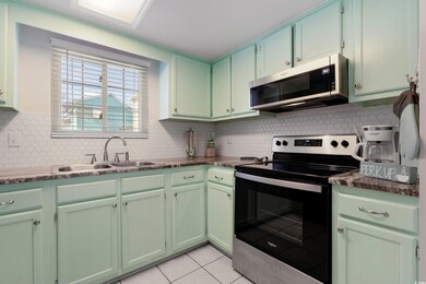 Kitchen featuring light tile patterned floors, dec