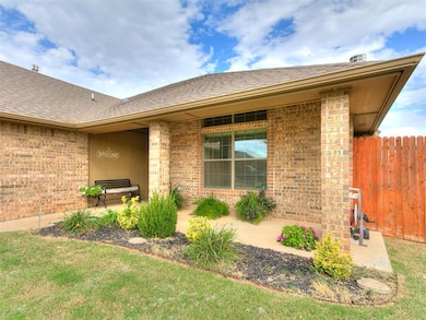 Doorway to property with brick siding, roof with shingles, and a patio