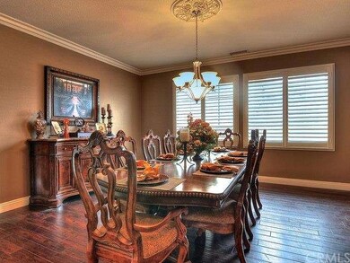 FORMAL DINING AREA WITH DARK FLOORING, CROWN MOLDI