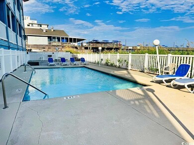 Community pool featuring fence and a patio