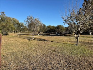 View of green lawn with a rural view