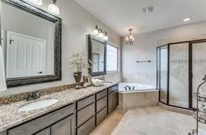 Bathroom featuring double vanity, a bath, a chandelier, light tile patterned floors, and a shower stall