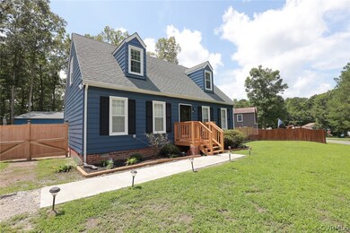 Cape cod home featuring a front lawn