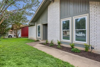 Entrance to property featuring brick siding, a ya
