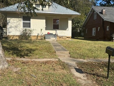 View of front of home featuring a front lawn and a porch