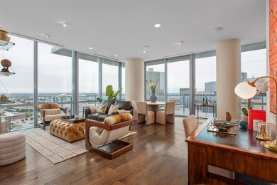 Living room with a wall of windows, a healthy amou