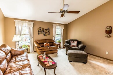  Living room has a vaulted ceiling,  2 windows vie