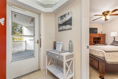 Entryway with ceiling fan, light tile patterned fl