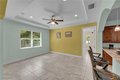 Family Room with a raised ceiling, ceiling fan, an