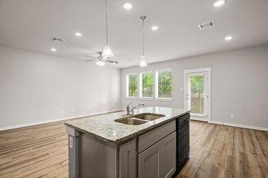 Kitchen featuring a sink, light wood finished flo
