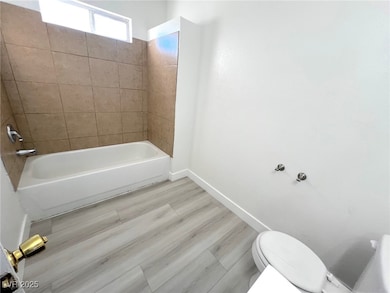 Bathroom with toilet, baseboards, and  shower comb