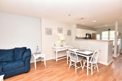 Dining room featuring a textured ceiling and light