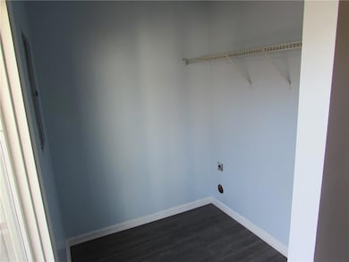 Washroom featuring baseboards, laundry area, dark 